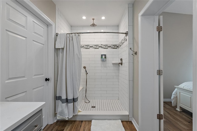 bathroom with hardwood / wood-style floors and curtained shower