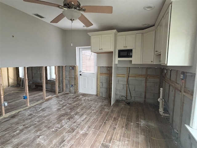 kitchen with white cabinetry, black microwave, ceiling fan, and dark hardwood / wood-style floors