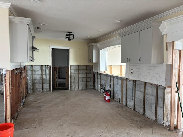 kitchen with crown molding and a healthy amount of sunlight