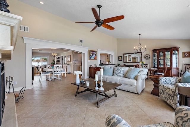 living room featuring a textured ceiling, high vaulted ceiling, and ceiling fan with notable chandelier