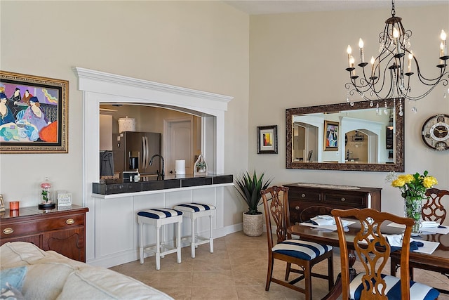 dining room with light tile patterned flooring and a notable chandelier