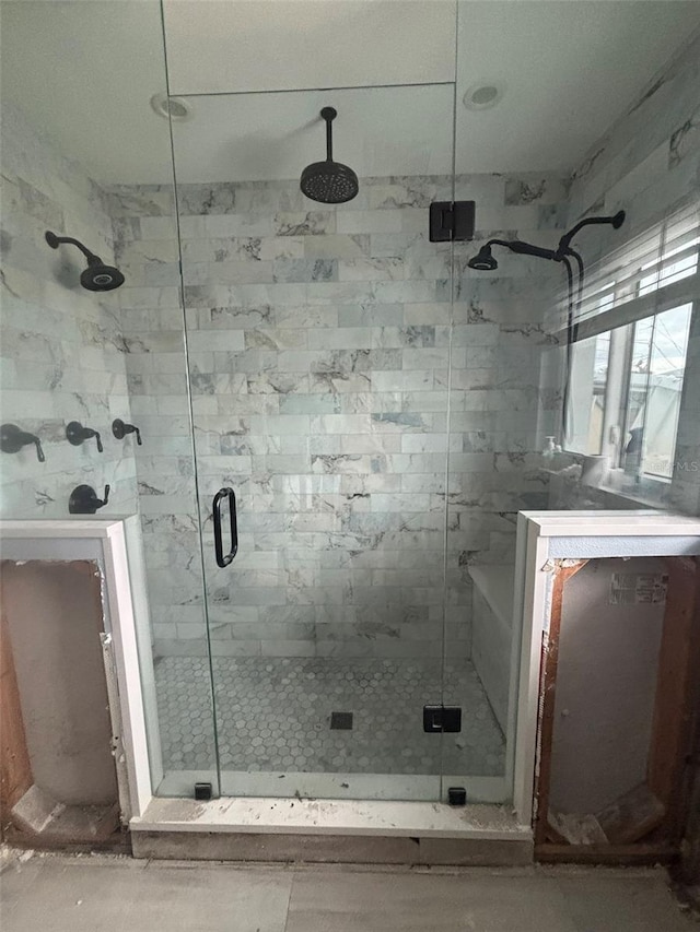 bathroom with a shower with door