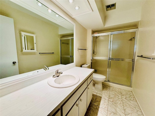 bathroom with vanity, toilet, and an enclosed shower