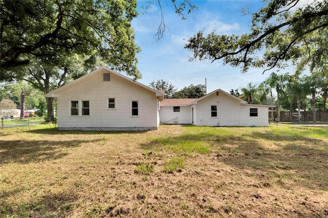 rear view of house with a yard