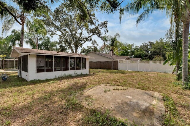 view of yard with a sunroom