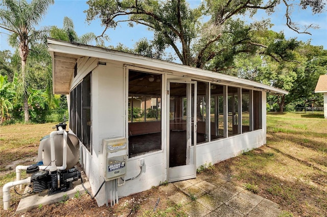 view of outdoor structure with a sunroom