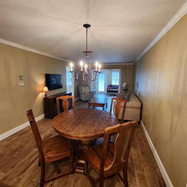 dining area featuring ornamental molding, an inviting chandelier, and hardwood / wood-style flooring