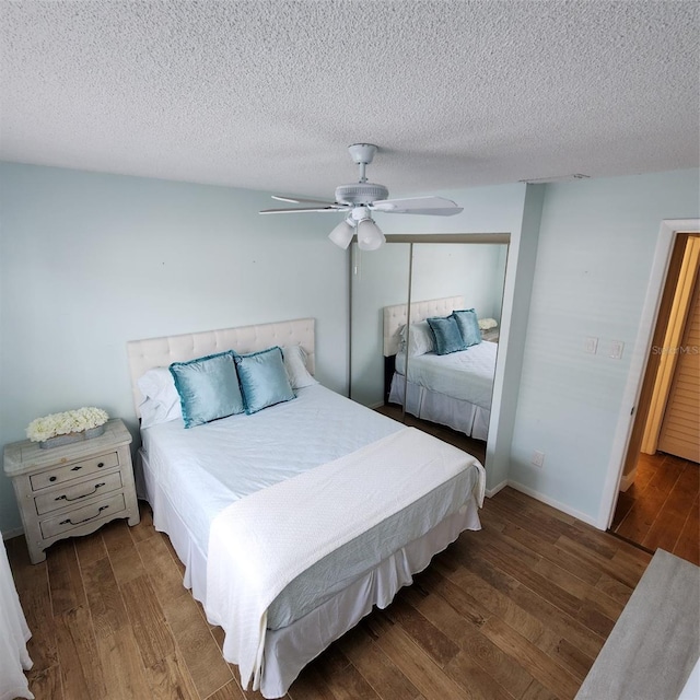 bedroom featuring a textured ceiling, dark hardwood / wood-style flooring, and ceiling fan