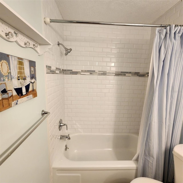 bathroom with a textured ceiling, toilet, and shower / tub combo with curtain