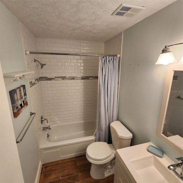 full bathroom with shower / bath combination with curtain, a textured ceiling, vanity, and toilet