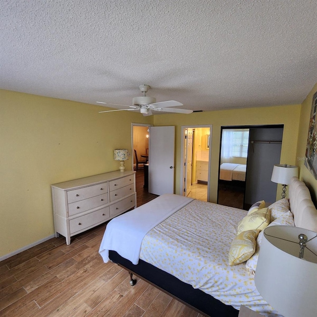 bedroom featuring light hardwood / wood-style flooring, connected bathroom, ceiling fan, and a textured ceiling