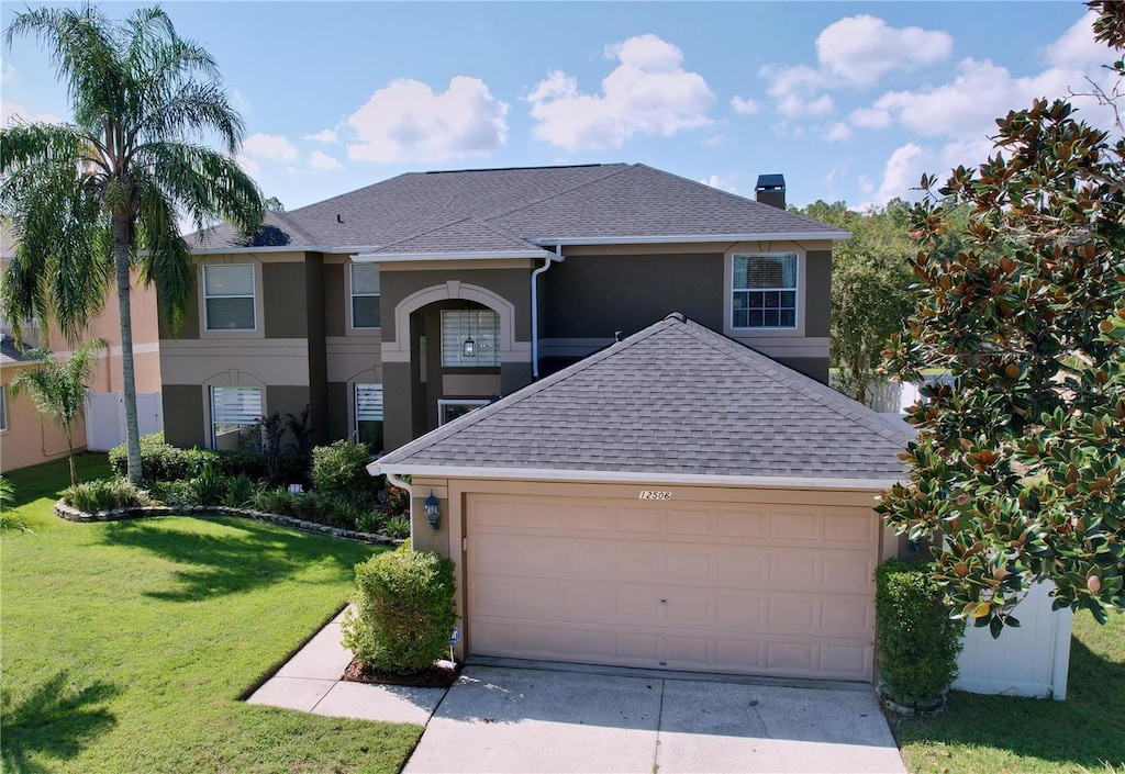 view of property with a front yard and a garage