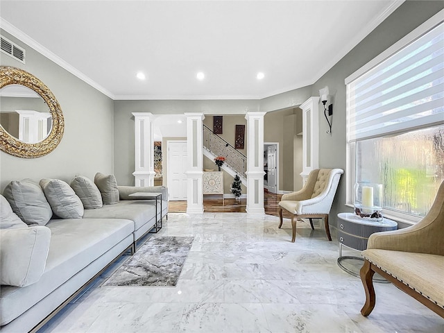 living room featuring ornate columns and ornamental molding