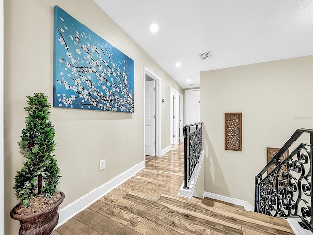 hallway with hardwood / wood-style floors