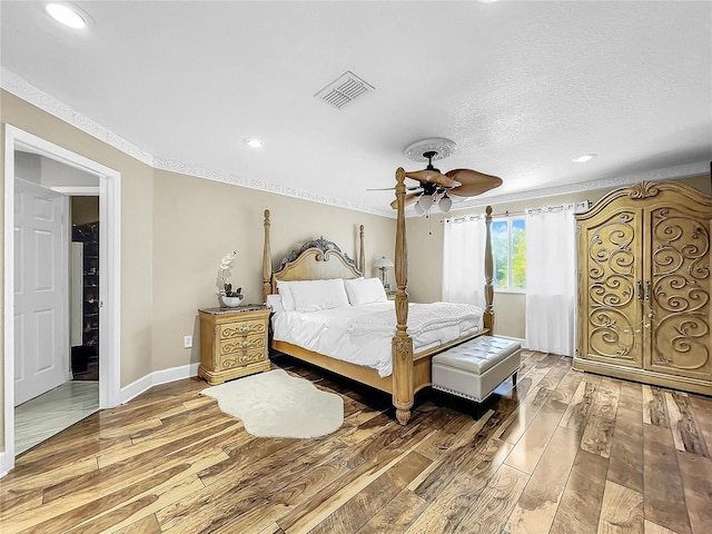 bedroom with hardwood / wood-style floors and ceiling fan