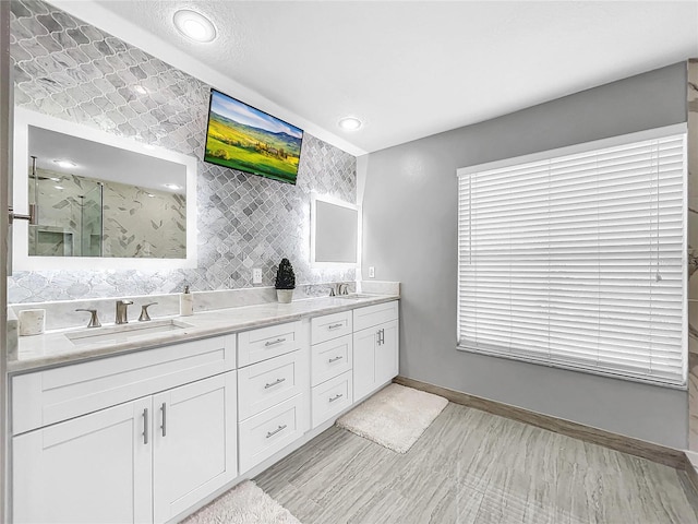 bathroom with vanity and a shower with shower door