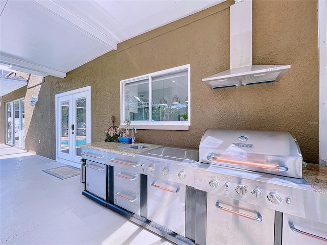 view of patio featuring grilling area, french doors, and sink