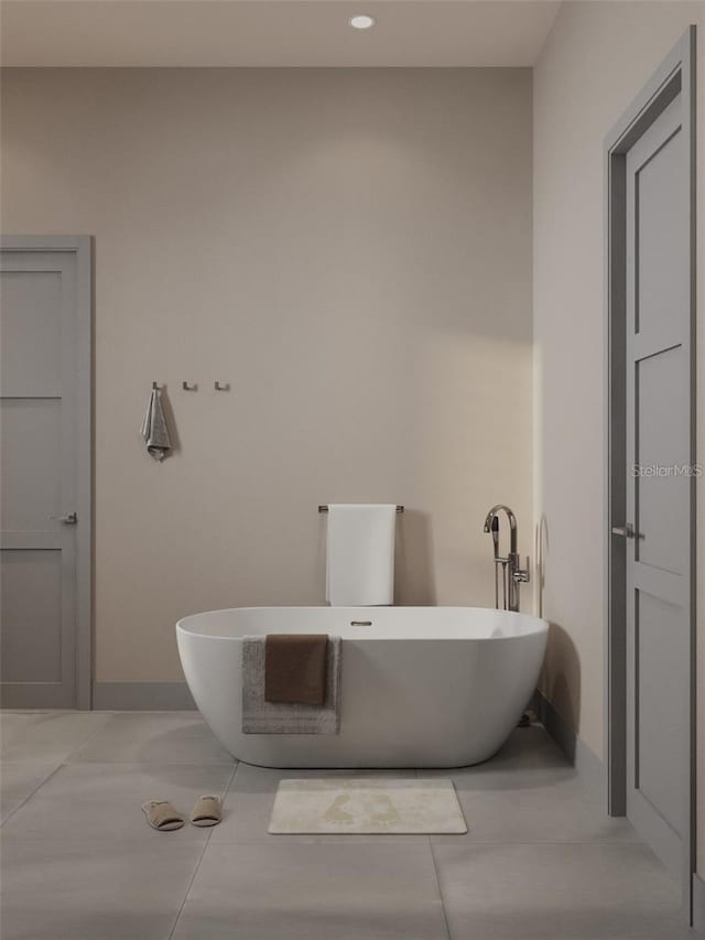 bathroom with a bath and tile patterned floors