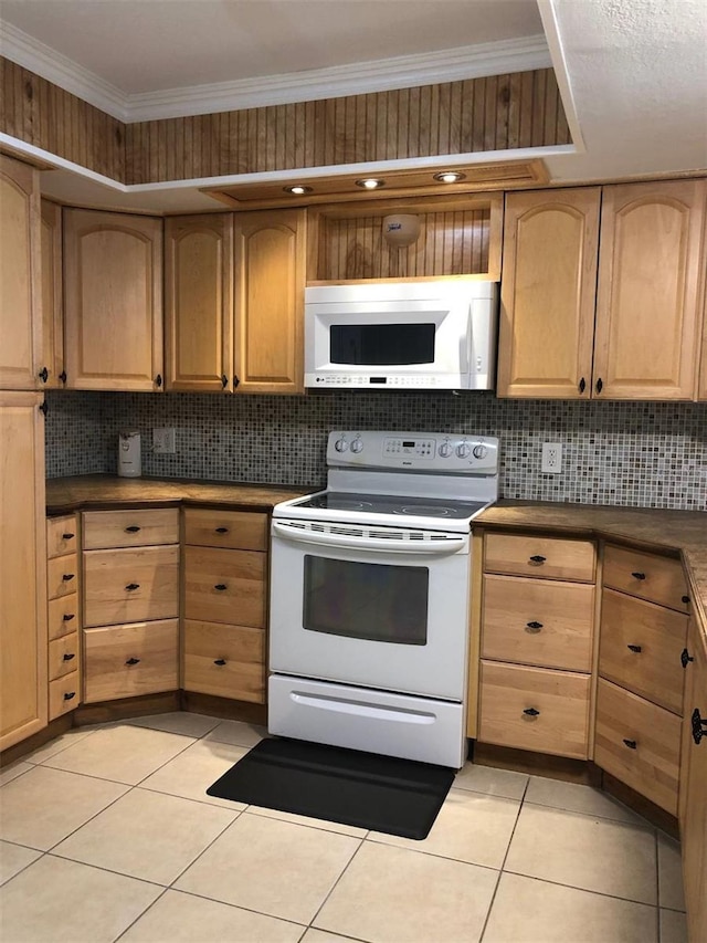 kitchen with ornamental molding, light tile patterned floors, and white appliances