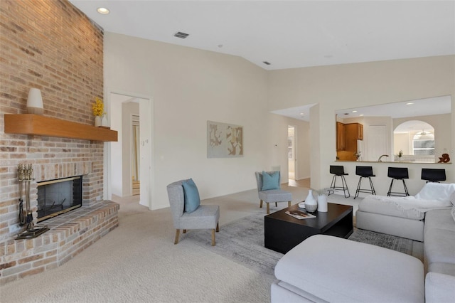 living room with light colored carpet, vaulted ceiling, and a fireplace