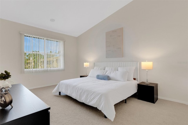 carpeted bedroom with lofted ceiling