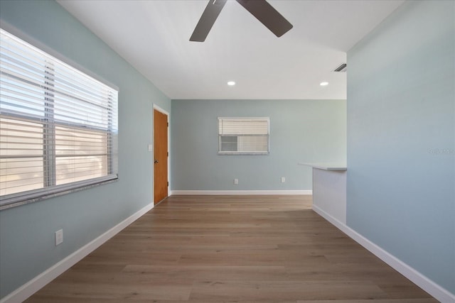 spare room featuring ceiling fan and hardwood / wood-style flooring