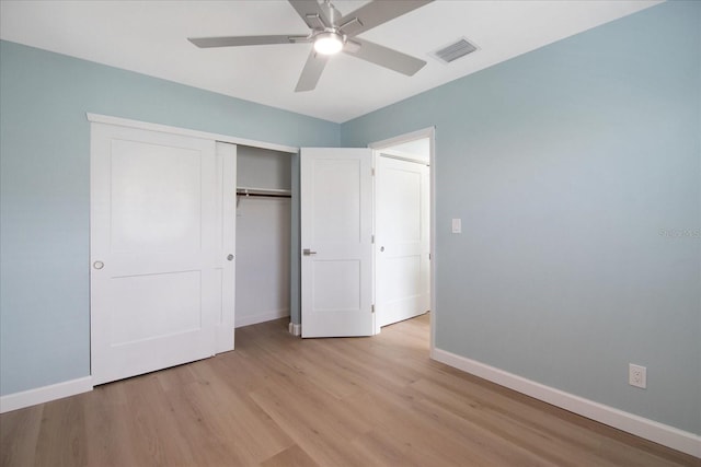 unfurnished bedroom with ceiling fan, a closet, and light hardwood / wood-style flooring