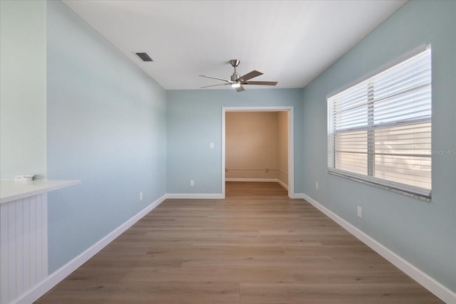 spare room with light wood-type flooring and ceiling fan