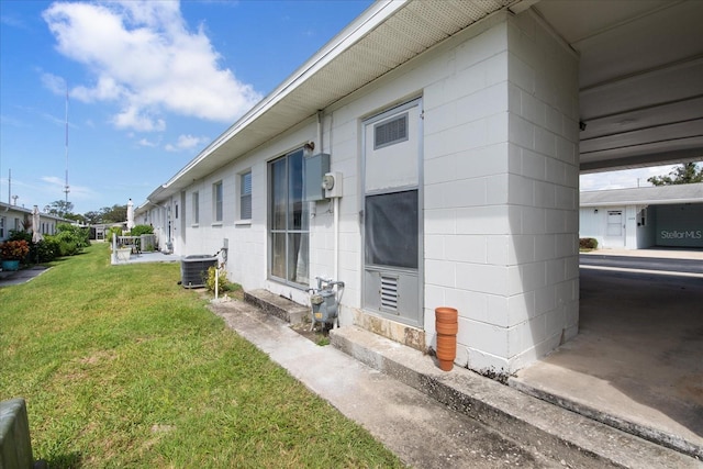 view of home's exterior with a yard and central air condition unit