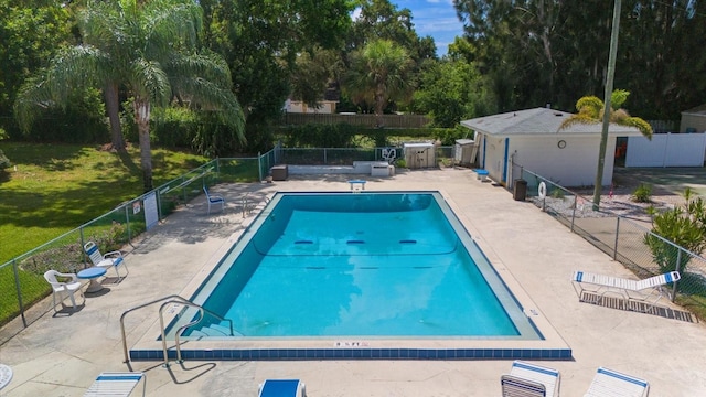 view of swimming pool with a lawn and a patio area