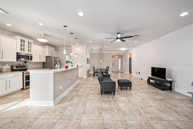 kitchen featuring a center island with sink, pendant lighting, stainless steel appliances, and ceiling fan