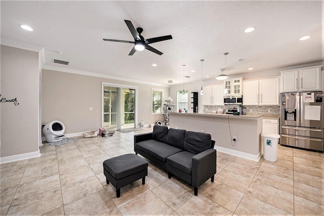 living room featuring crown molding, a textured ceiling, light tile patterned floors, and ceiling fan