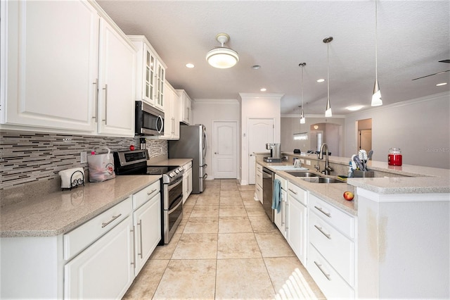 kitchen with appliances with stainless steel finishes, white cabinets, decorative light fixtures, and sink