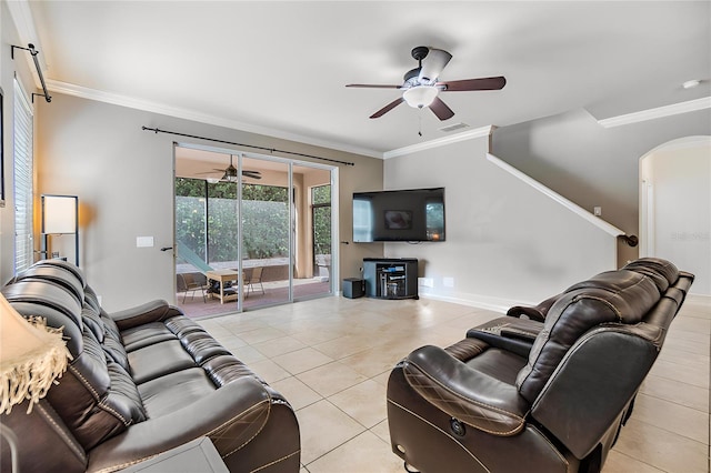 tiled living room with ceiling fan and crown molding