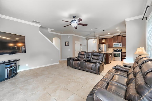 living room with ceiling fan, ornamental molding, and light tile patterned flooring