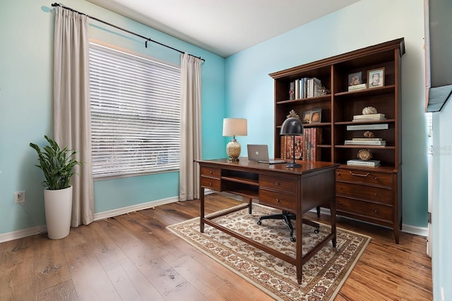 home office with hardwood / wood-style flooring