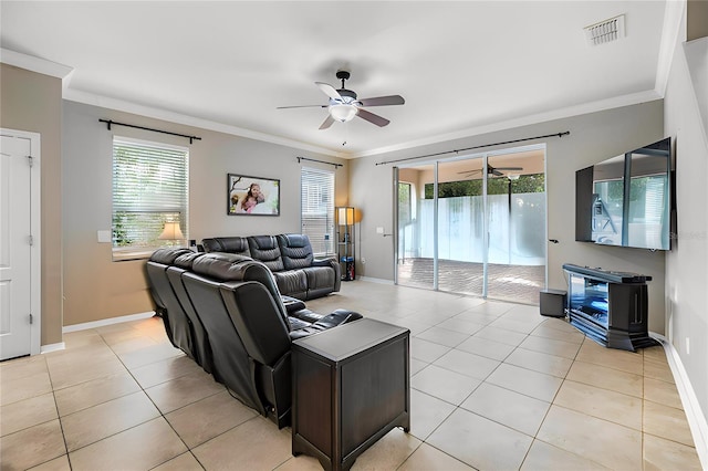 tiled living room with plenty of natural light, crown molding, and ceiling fan