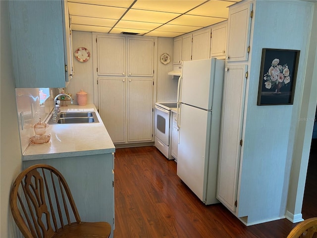 kitchen featuring white appliances, ventilation hood, a drop ceiling, dark hardwood / wood-style floors, and sink