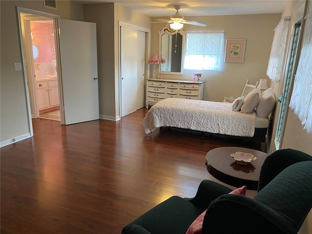 bedroom with hardwood / wood-style floors, ceiling fan, ensuite bath, and a closet