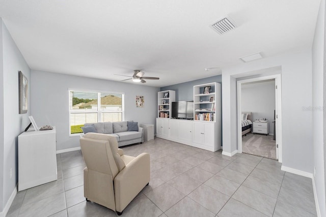684 SE 65th Ter, Ocala, FL 34472 - living area featuring ceiling fan, light tile patterned flooring, baseboards, and built in shelves