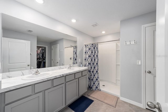684 SE 65th Ter, Ocala, FL 34472 - full bath with a shower stall, a spacious closet, double vanity, tile patterned floors, and baseboards