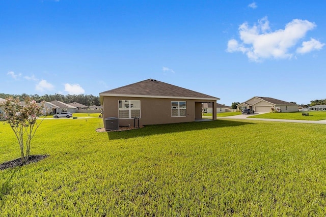 684 SE 65th Ter, Ocala, FL 34472 - view of side of property with stucco siding, a yard, and central AC