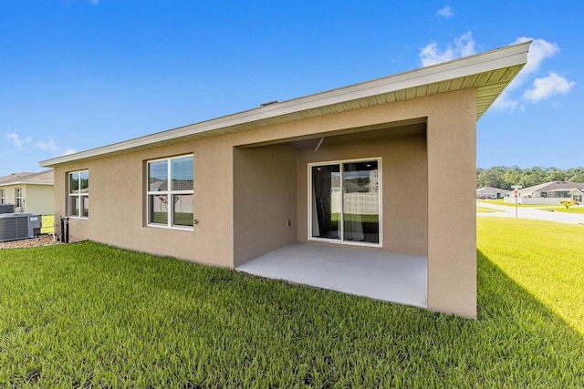 684 SE 65th Ter, Ocala, FL 34472 - rear view of property with stucco siding, a yard, a patio area, and cooling unit