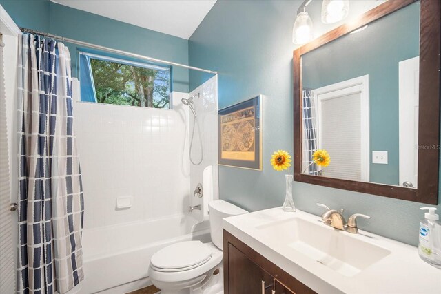 full bathroom with shower / tub combo, vanity, and toilet