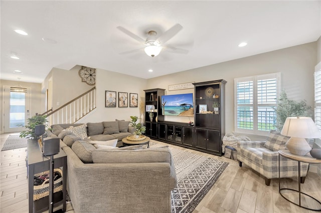 living room featuring ceiling fan and light wood-type flooring