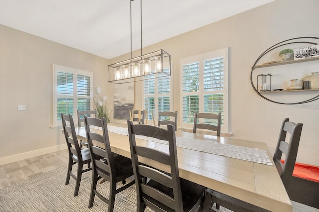 dining space with a chandelier, hardwood / wood-style floors, and a healthy amount of sunlight