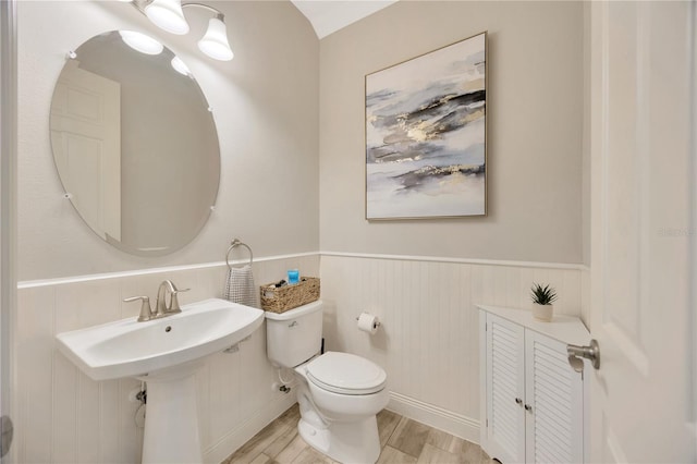 bathroom with wood-type flooring and toilet