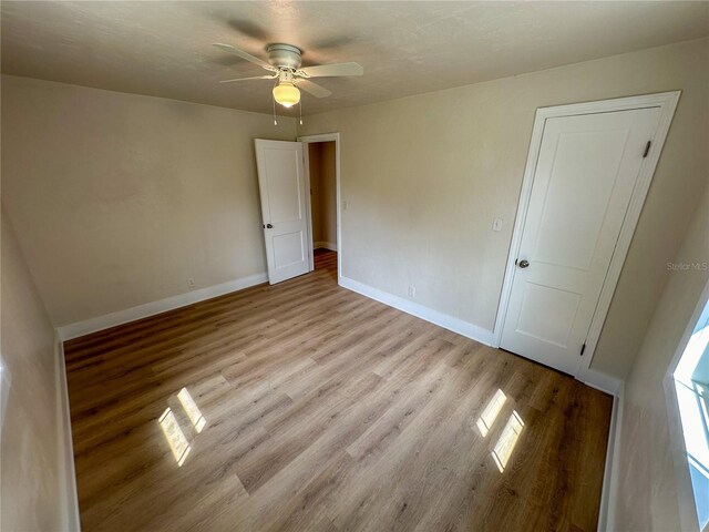 unfurnished room with light hardwood / wood-style floors and ceiling fan