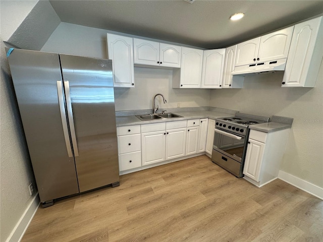 kitchen featuring white cabinets, appliances with stainless steel finishes, light wood-type flooring, and sink