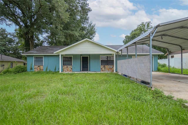 single story home with a carport and a front lawn